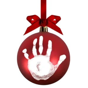 Red ornament with white handprint and bow.